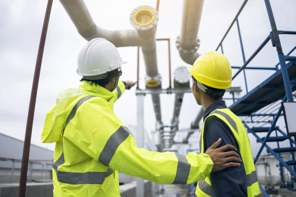 Mechanical engineer working install chilled water pipe system. Engineer consult discussion with team work for install pipe.