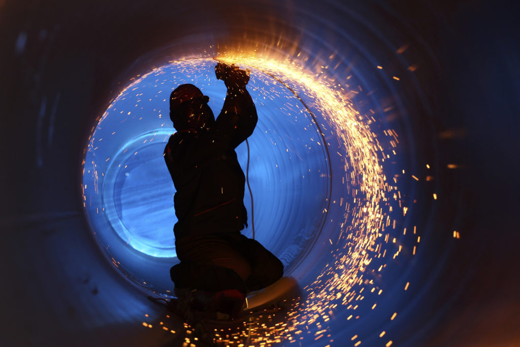 a man welding a pipeline